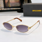 Sunglasses with gold frame, tortoise accents, and light purple tinted lenses