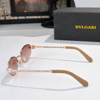 Sunglasses with rose gold frame and pink tinted lenses, side view