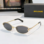Sunglasses with gold frame and dark gray tinted lenses