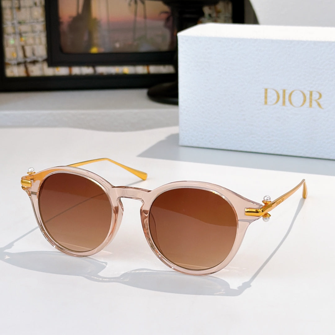 Round sunglasses with light rose frames and brown tinted lenses