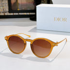 Round sunglasses with gold-tone frames and brown tinted lenses
