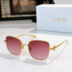Gold-tone sunglasses with pink tinted lenses and slim angled temples