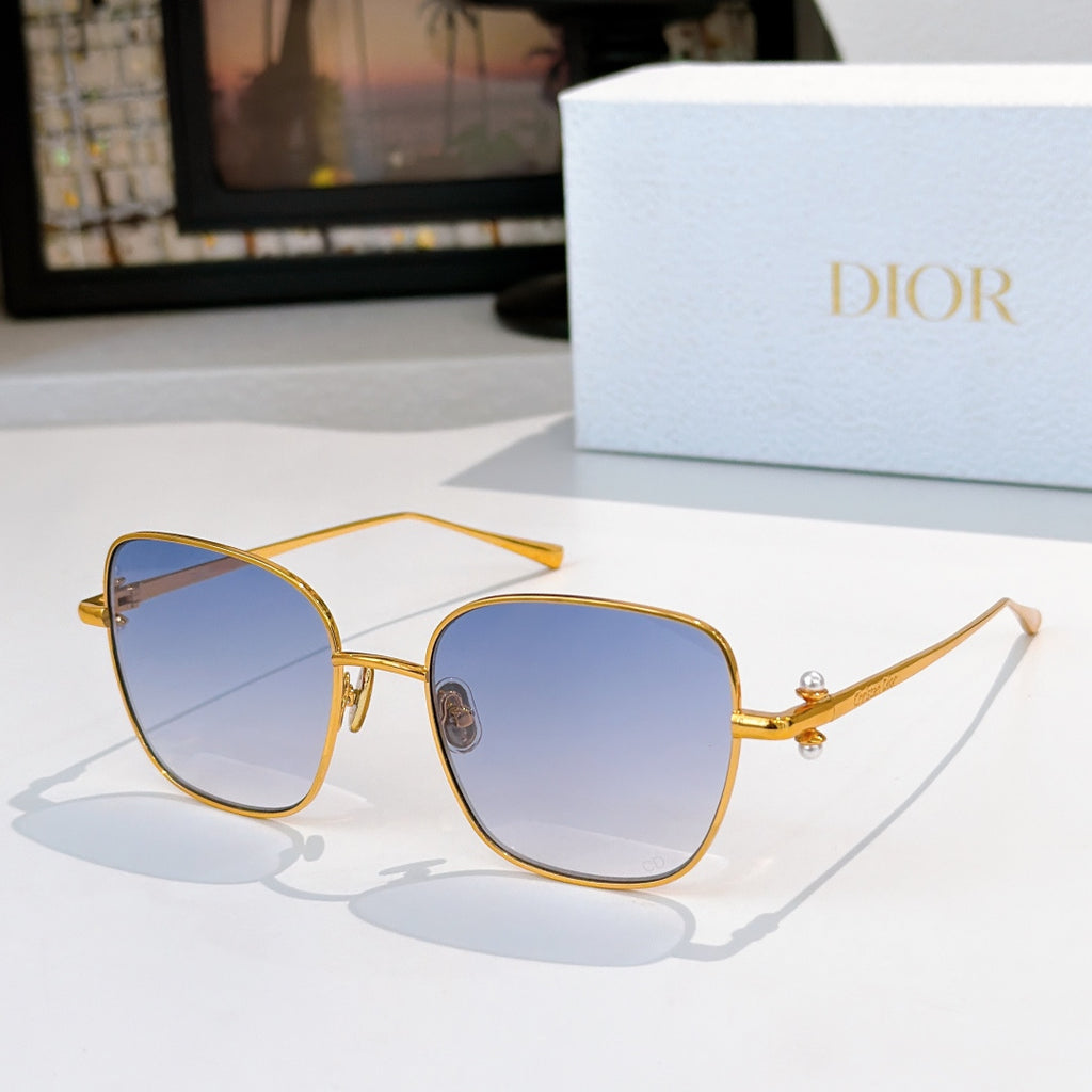 Gold-tone sunglasses with light blue tinted lenses and slim angled temples
