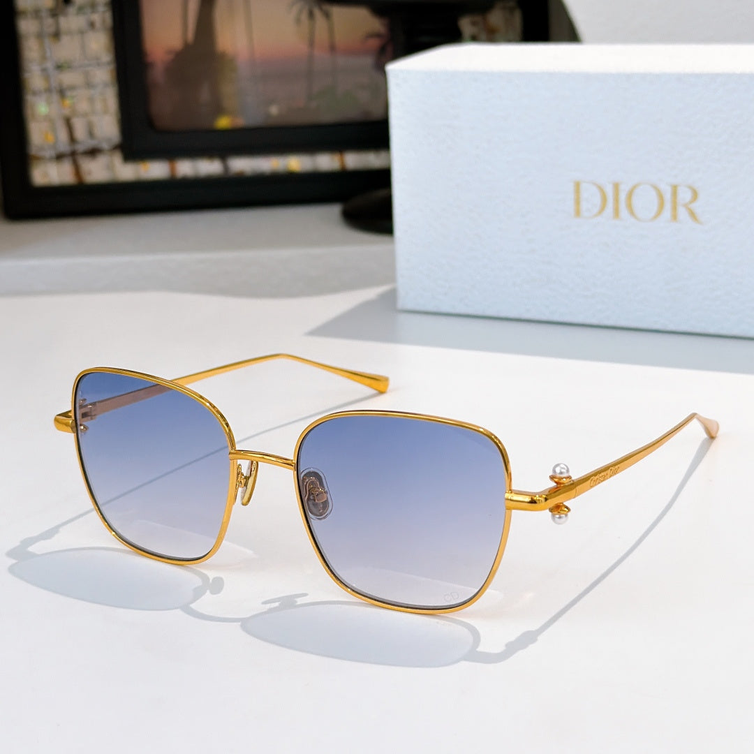 Gold-tone sunglasses with light blue tinted lenses and slim angled temples