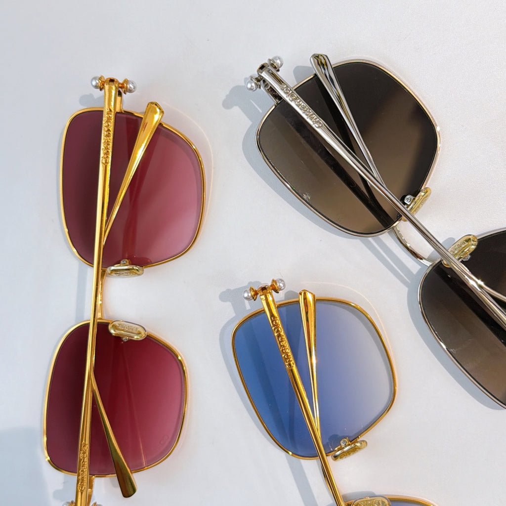 Assorted sunglasses with gold and silver frames, red, blue, and black tinted lenses