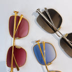 Assorted sunglasses with gold and silver frames, red, blue, and black tinted lenses