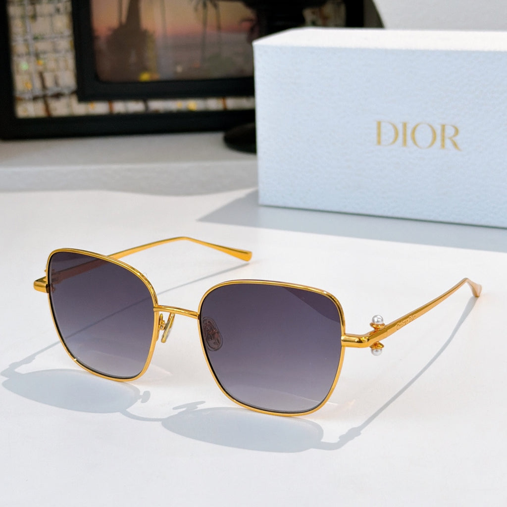Gold-tone sunglasses with dark blue tinted lenses and slim angled temples