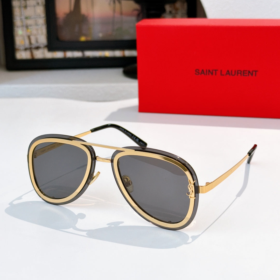 Dior sunglasses with gold and black frames and dark gray tinted lenses