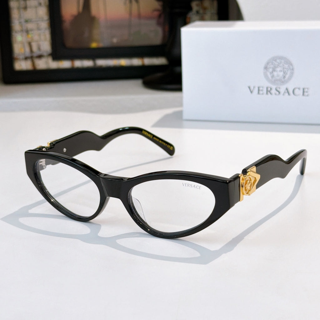 Black cat-eye sunglasses with dark lenses and gold crest on temples