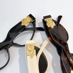 Gold medallion detail on sunglasses temples with black and tortoiseshell frames