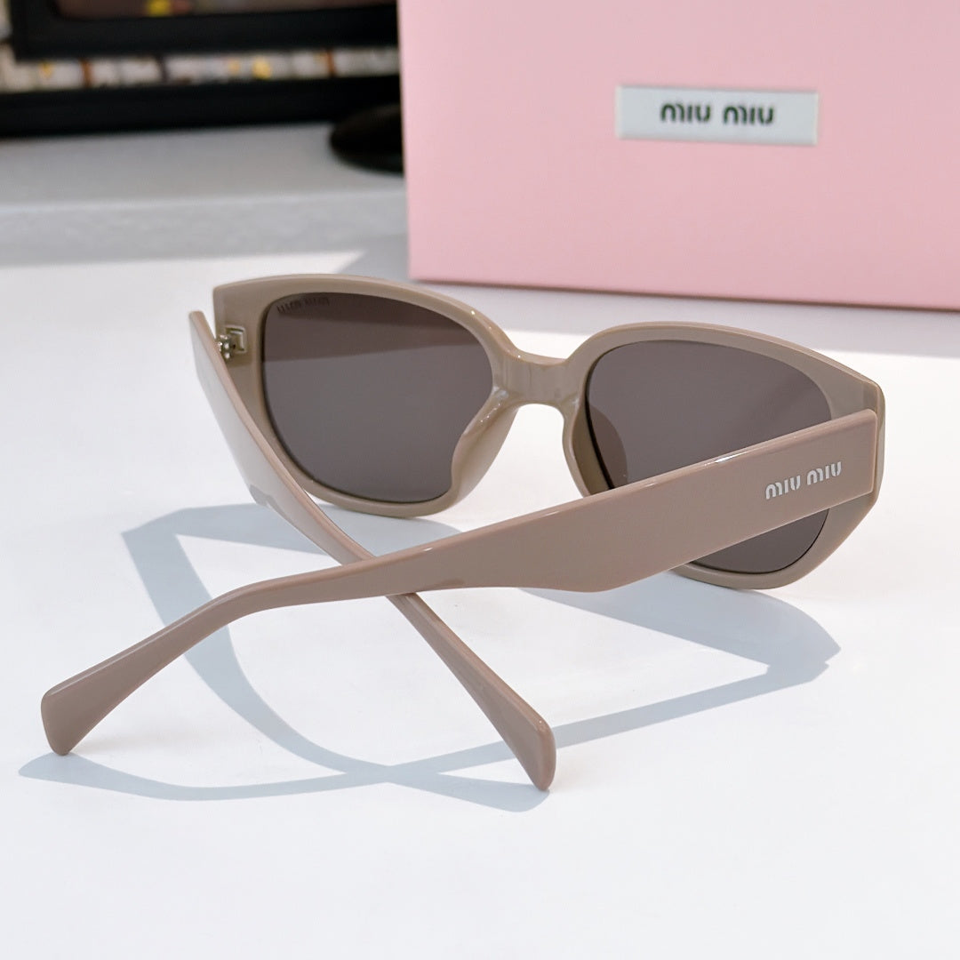 Cat-eye sunglasses with light beige frame and dark tinted lenses