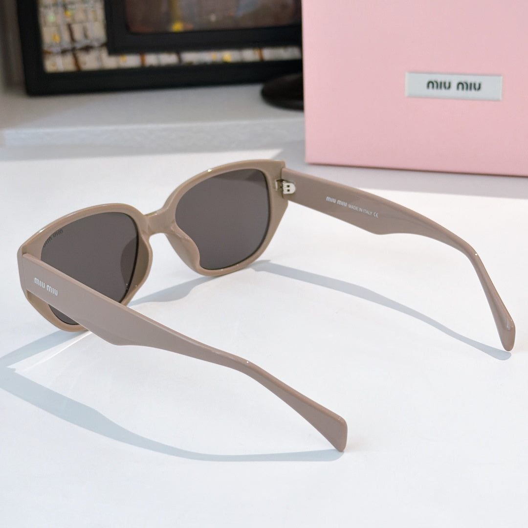 Cat-eye sunglasses side view with light beige frame and dark tinted lenses