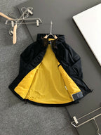Black long jacket with bright yellow inner lining and front zipper opening