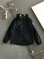 Black hooded long jacket with front snap buttons and stand collar