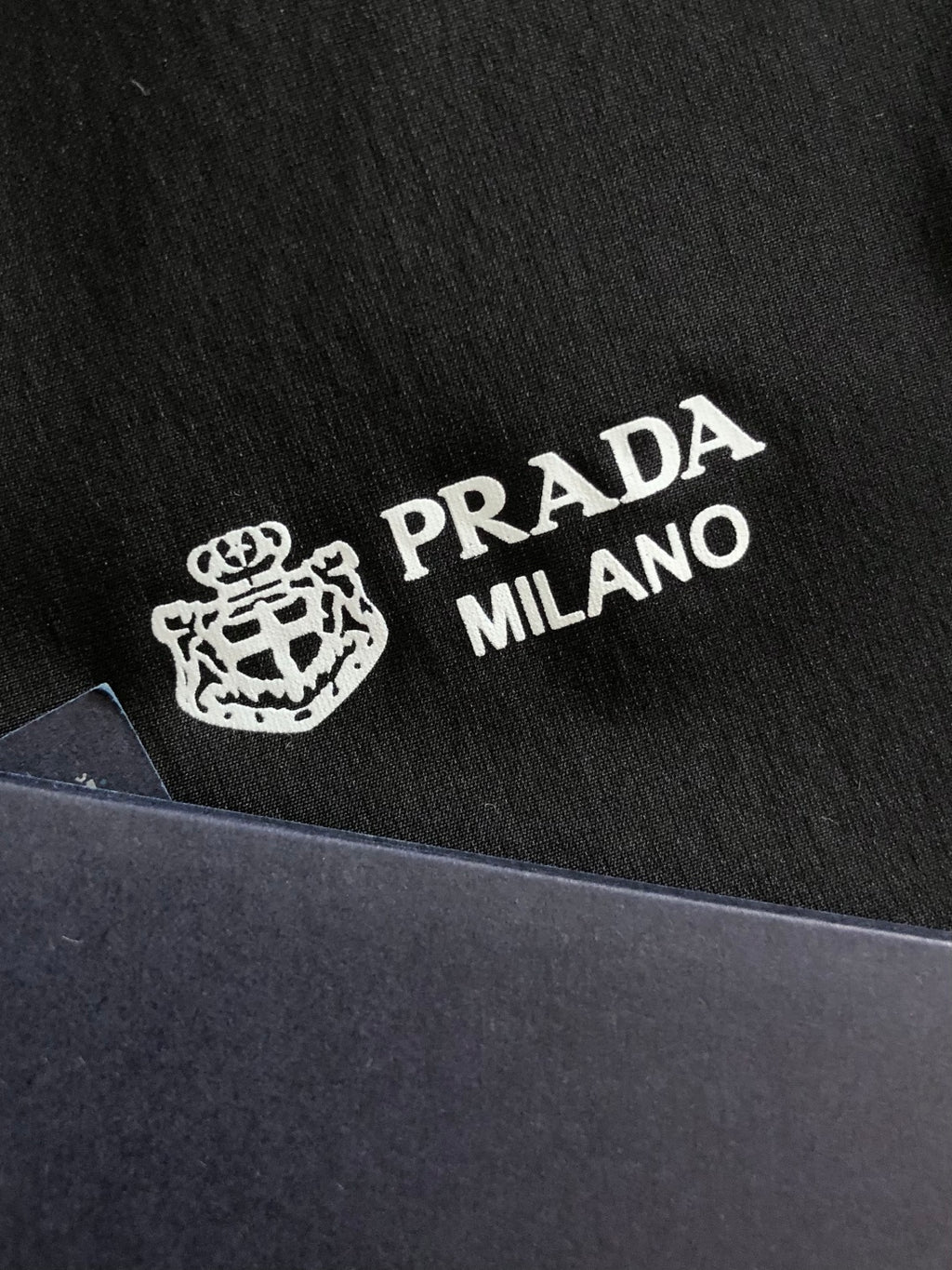 Prada Milano logo print on black jacket fabric
