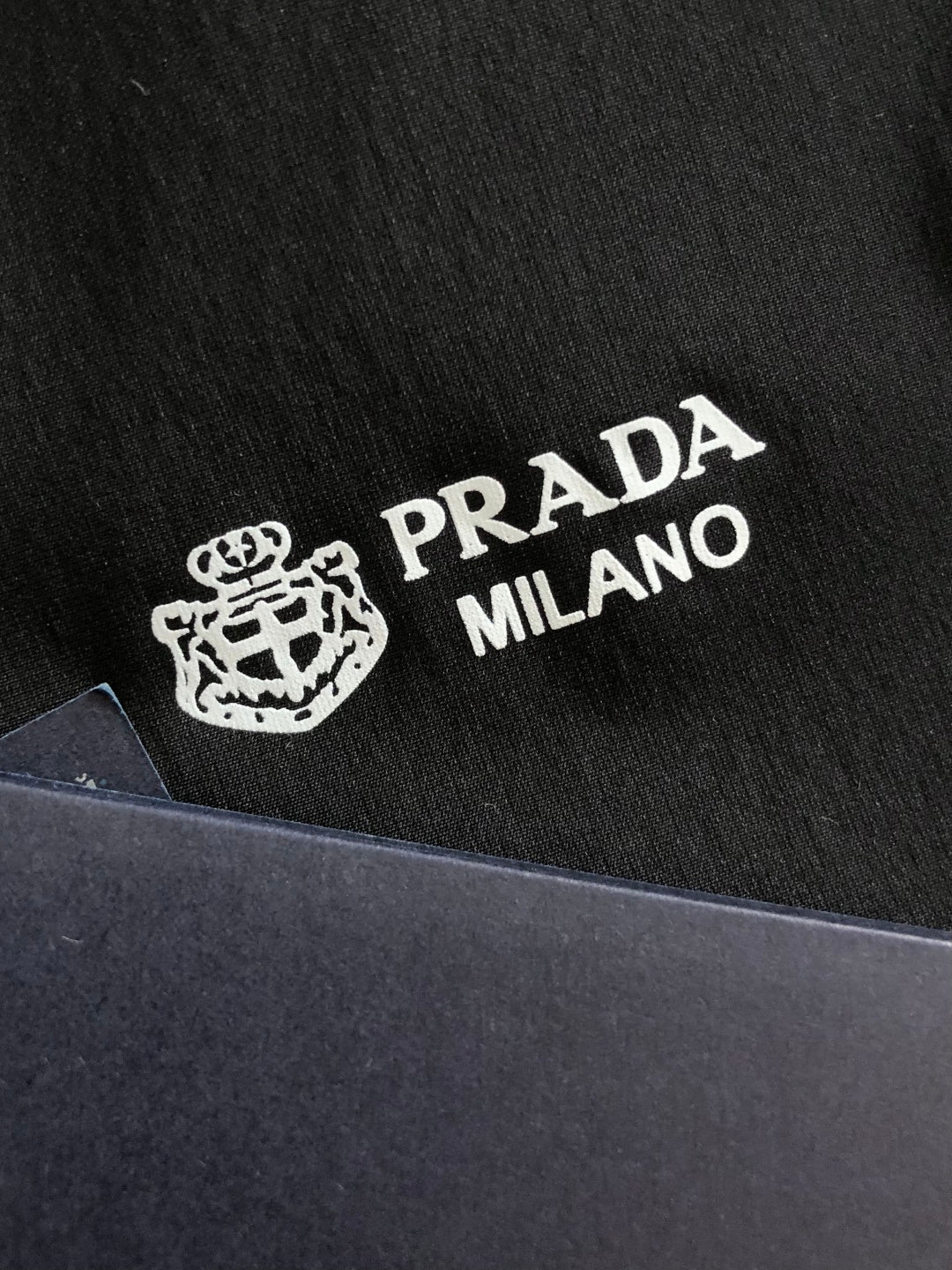 Prada Milano logo print on black jacket fabric
