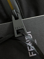 Black jacket chest close-up with FENDI logo label and zipper pull