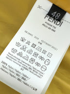 Yellow garment care label with FENDI ROMA text and washing symbols