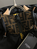 Black jacket with tan and brown patterned FENDI trim and drawstring hood