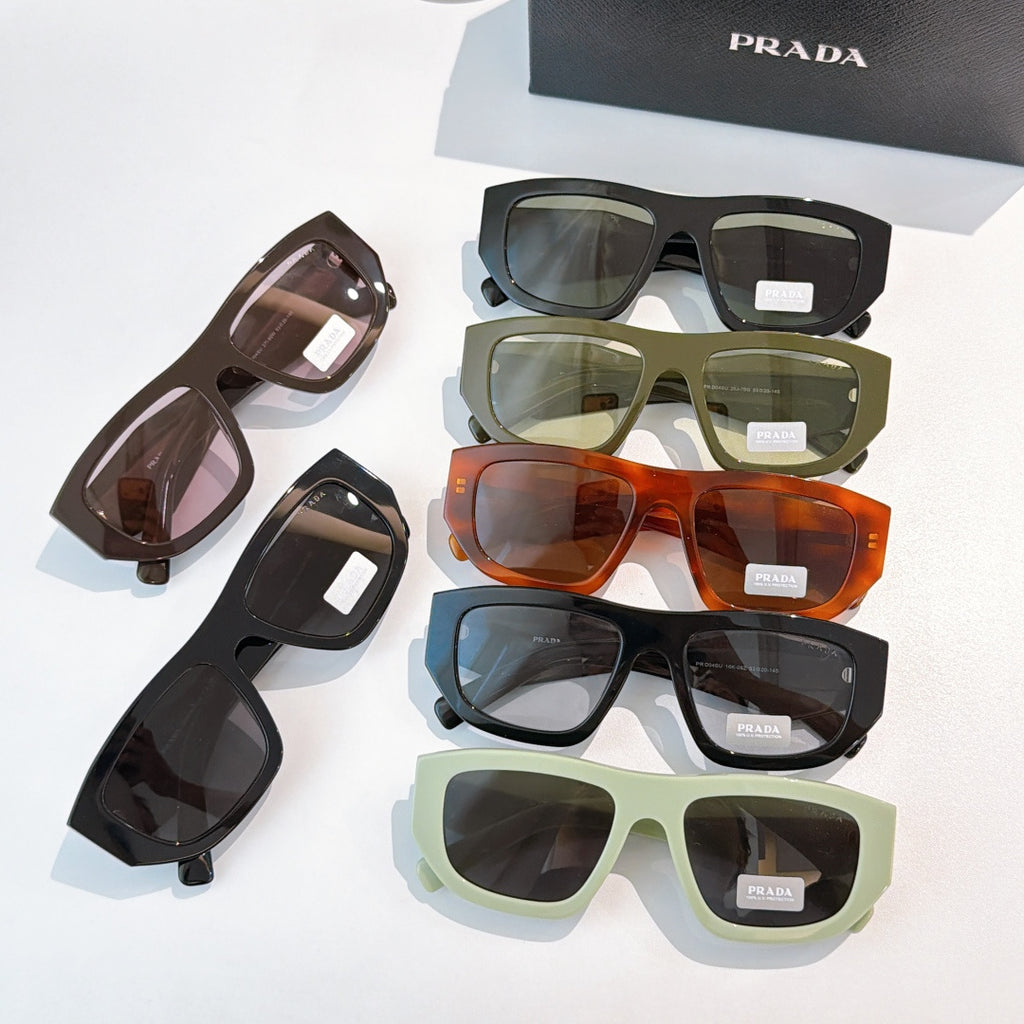 Assorted sunglasses with Prada temples in black, green, orange, and brown tones