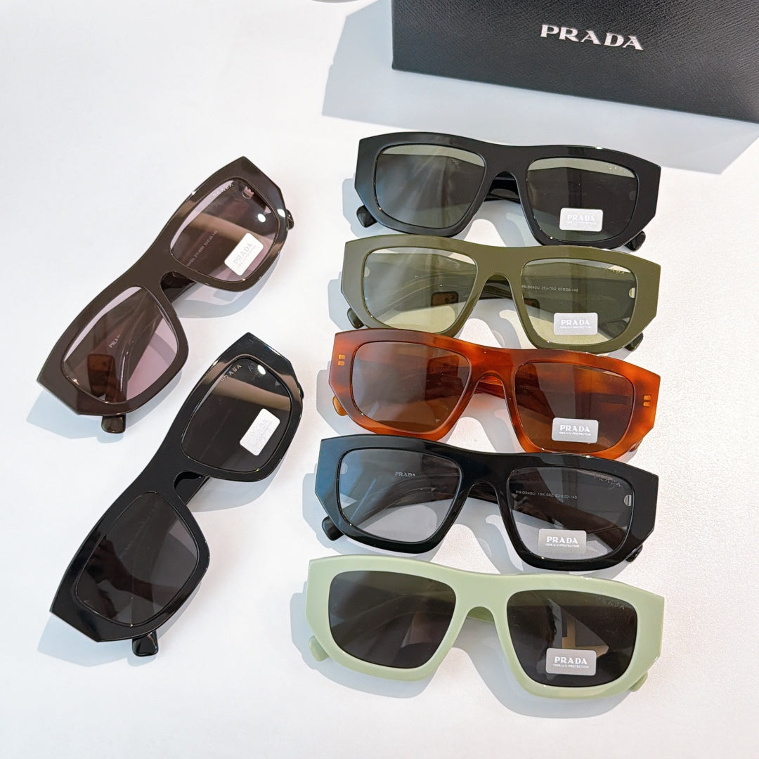Assorted sunglasses with Prada temples in black, green, orange, and brown tones
