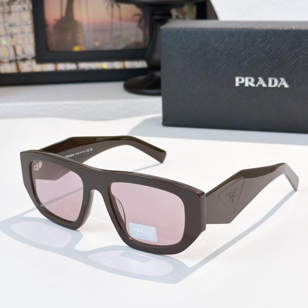 Sunglasses with dark frames and pink-tinted lenses, Prada logo on temple