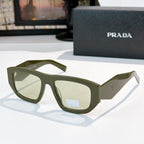 Sunglasses with olive frames and green-tinted lenses, Prada logo on temple