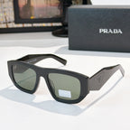 Sunglasses with black frames and light green lenses, Prada logo on temple