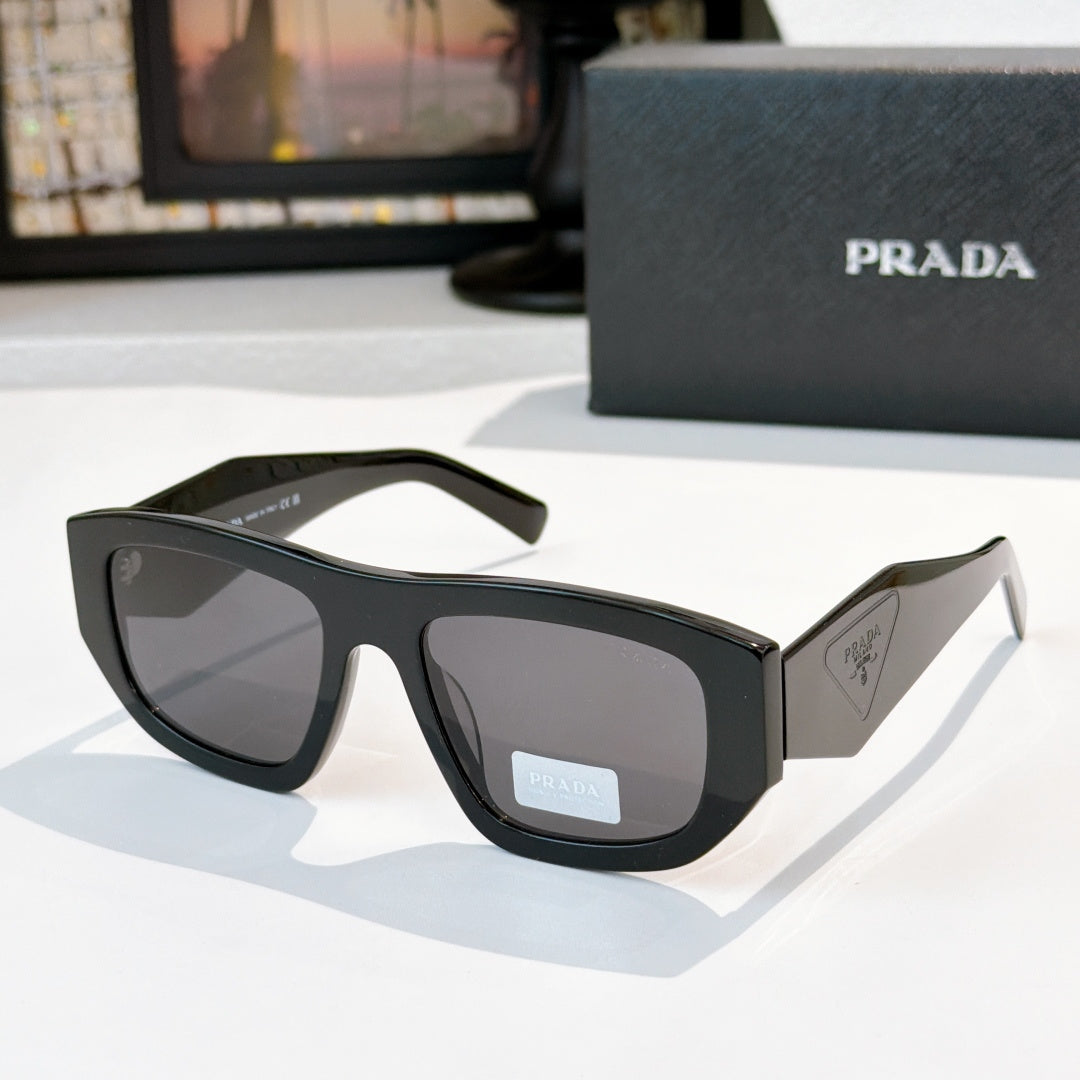 Sunglasses with black frames and dark gray lenses, Prada logo on temple