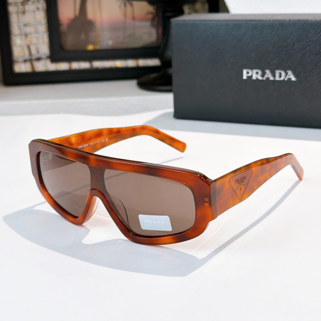 Prada sunglasses with amber tortoiseshell frames and tinted lenses, full-rim style