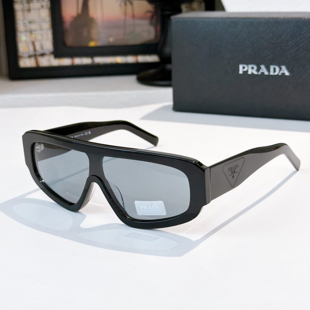Prada sunglasses in dark charcoal with tinted lenses, chunky full-rim frame