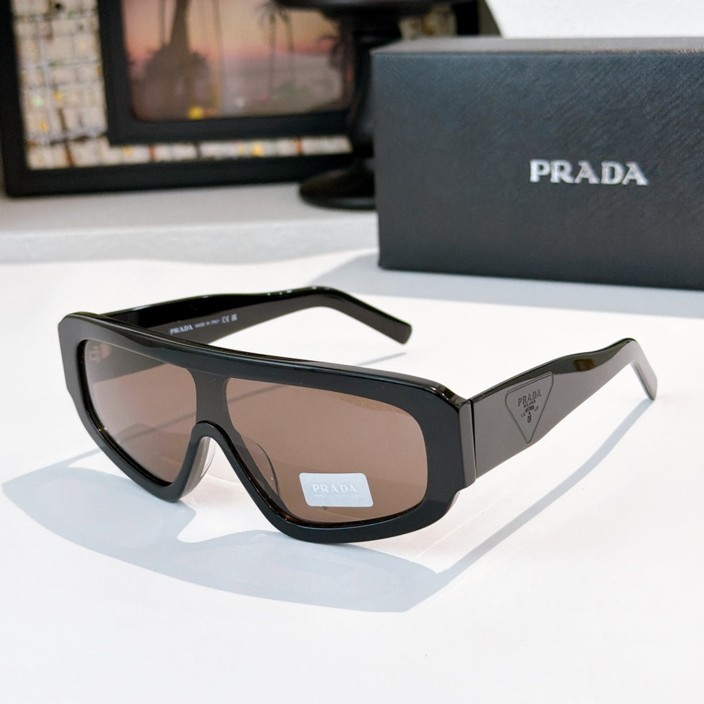 Prada sunglasses with black full-rim frames and tinted lenses, sculpted temple arms