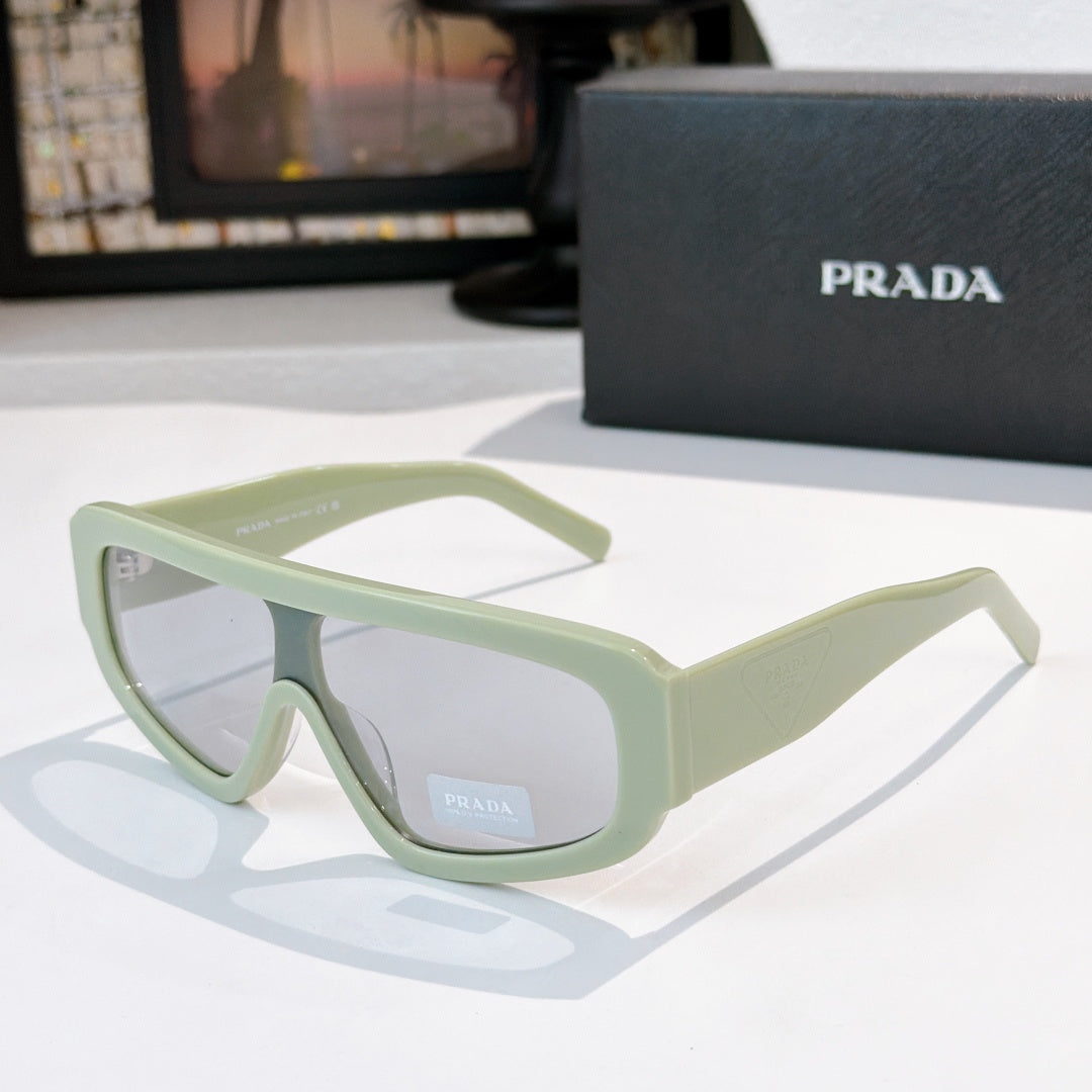 Prada sunglasses in light mint green with tinted lenses, angular full-rim frame