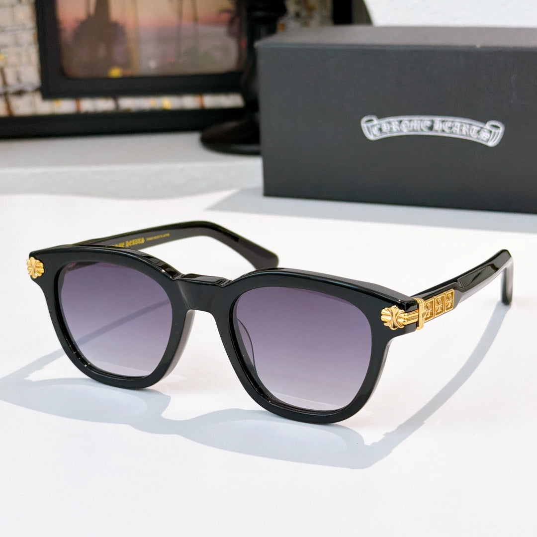 Black acetate glasses with purple-tinted lenses and gold temple emblem detail