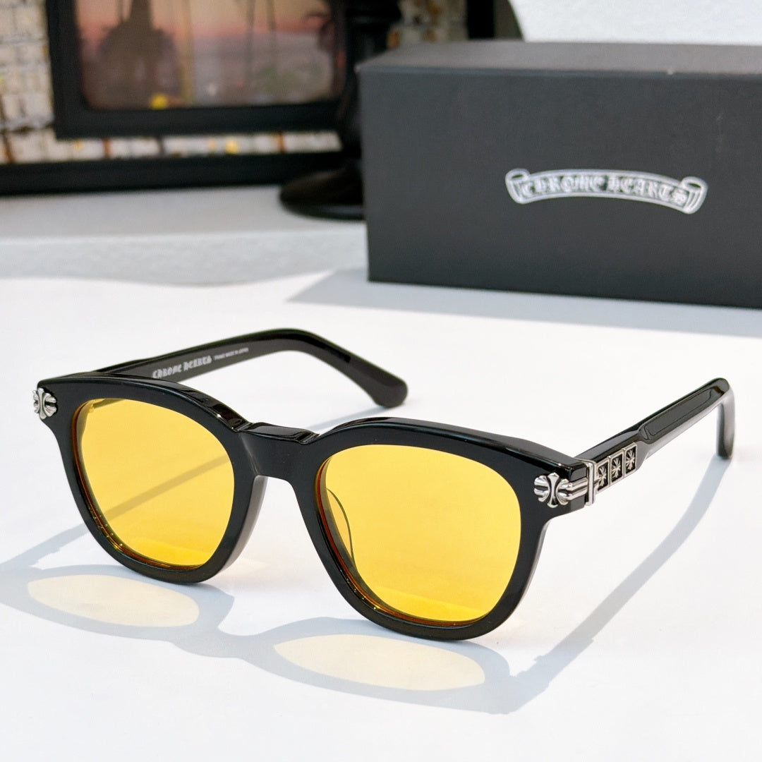 Black acetate glasses with yellow-tinted lenses and silver temple logo detail