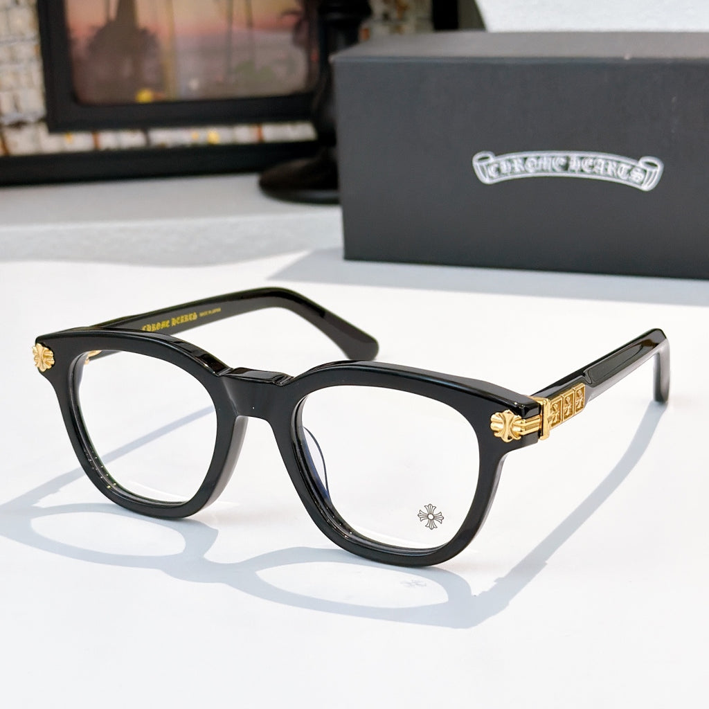 Black acetate glasses with clear lenses and gold temple emblem detail