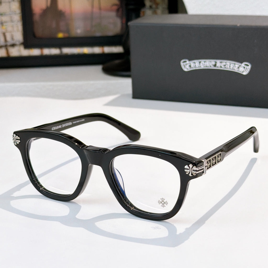 Black acetate glasses with clear lenses and silver temple emblem detail