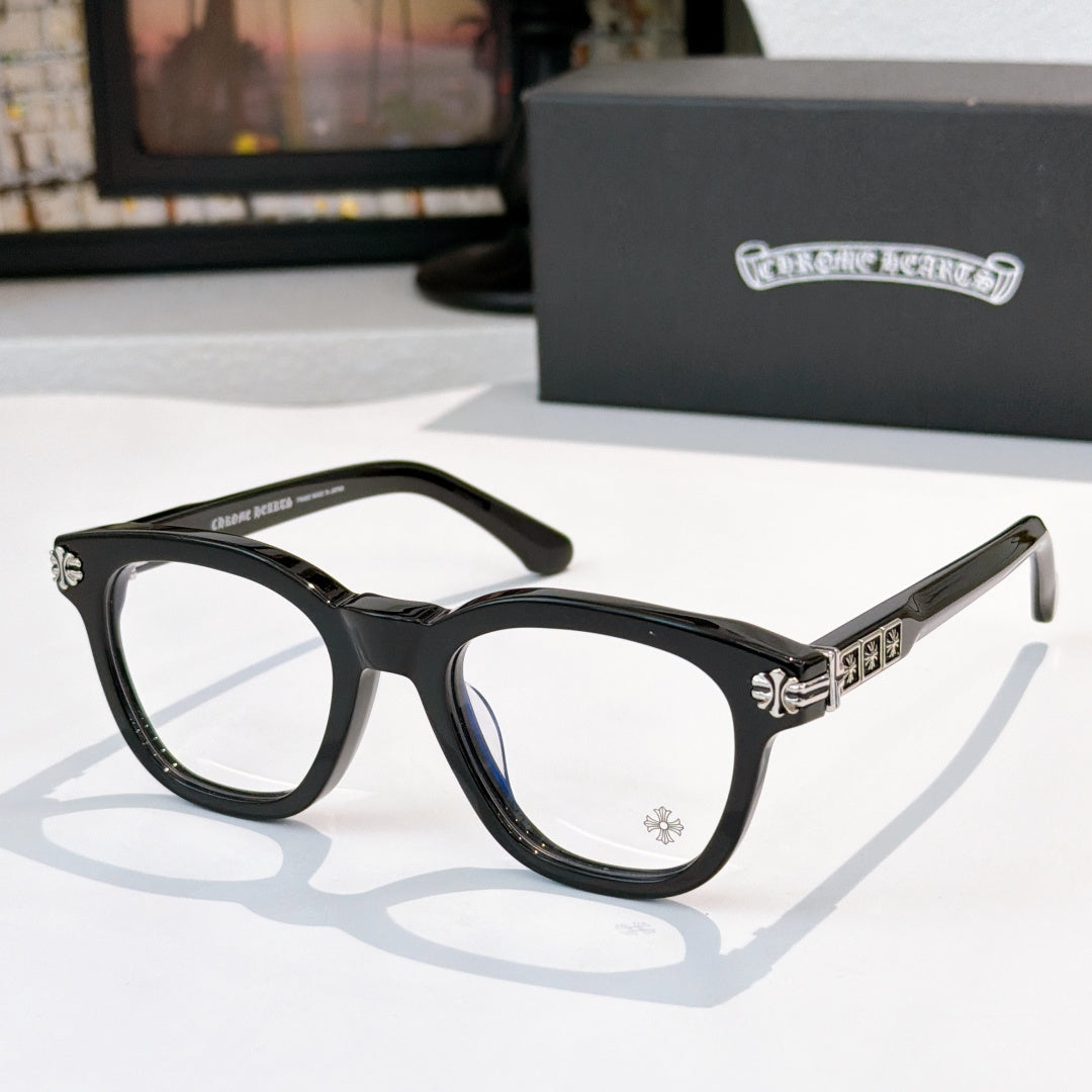 Black acetate glasses with clear lenses and silver temple emblem detail