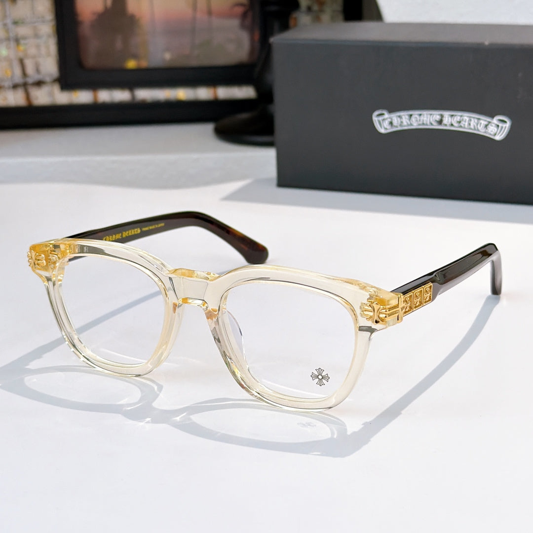 Light amber acetate glasses with clear lenses and gold temple emblem detail