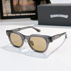 Oval sunglasses with dark frame and brown tinted lenses, metal temples and arms.