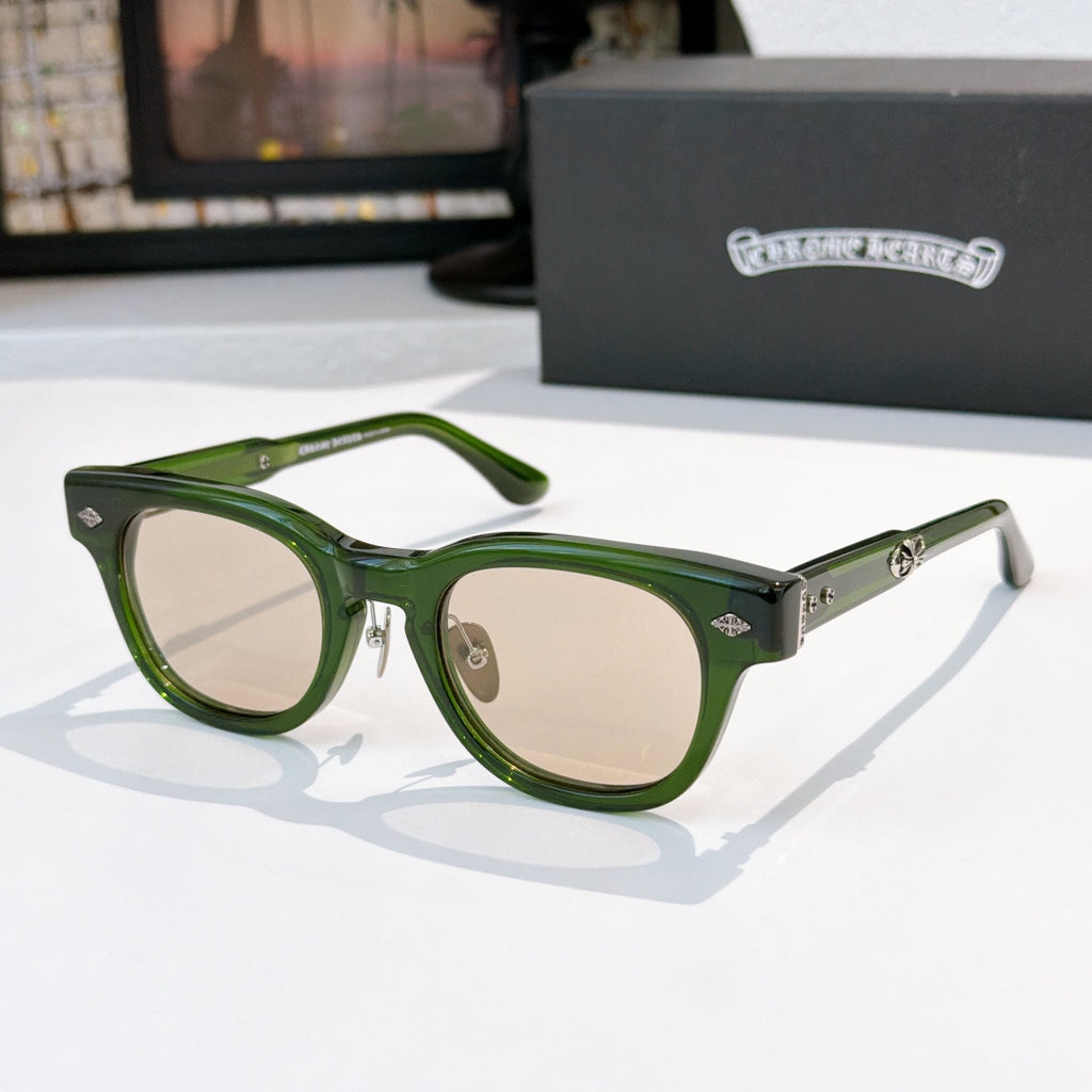 Oval sunglasses with green frame and light beige tinted lenses, metal temples and arms.