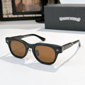 Oval sunglasses with black frame and brown tinted lenses, metal temples and arms.
