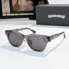 Oval sunglasses with dark gray frame and dark gray tinted lenses, metal temples and arms.