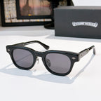 Oval sunglasses with black frame and dark gray tinted lenses, metal temples and arms.