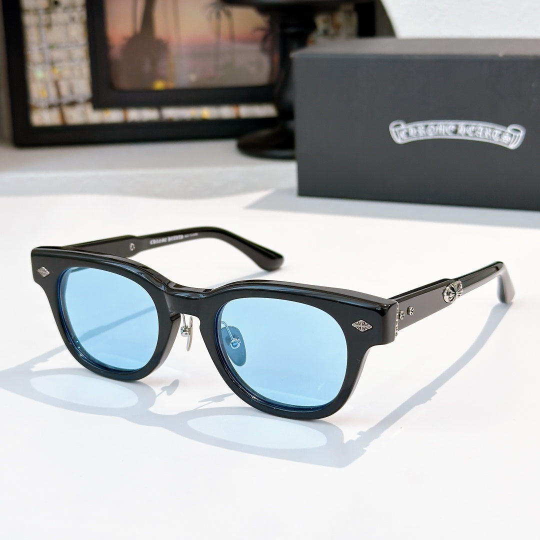 Oval sunglasses with black frame and blue tinted lenses, metal temples and arms.