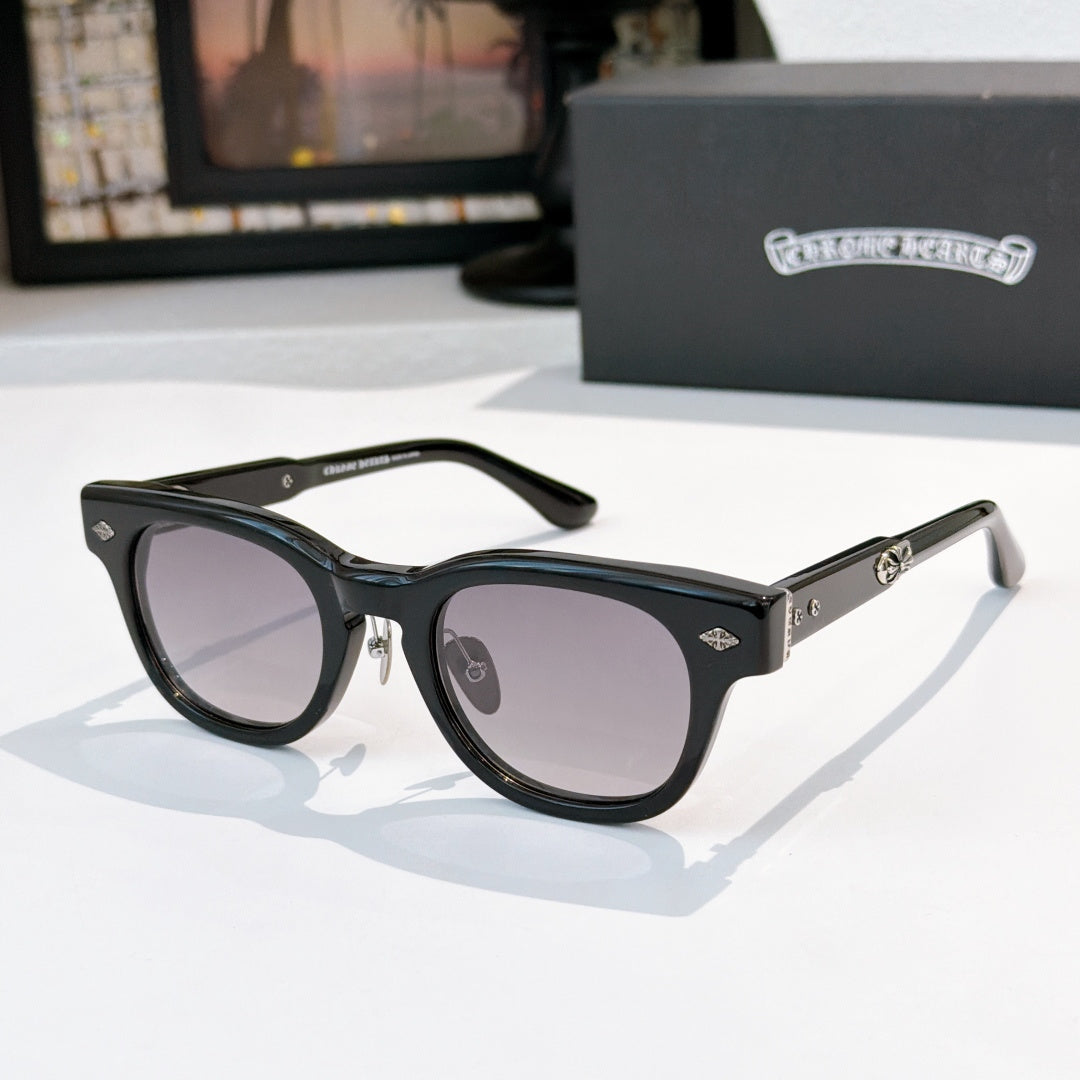 Oval sunglasses with black frame and light purple tinted lenses, metal temples and arms.