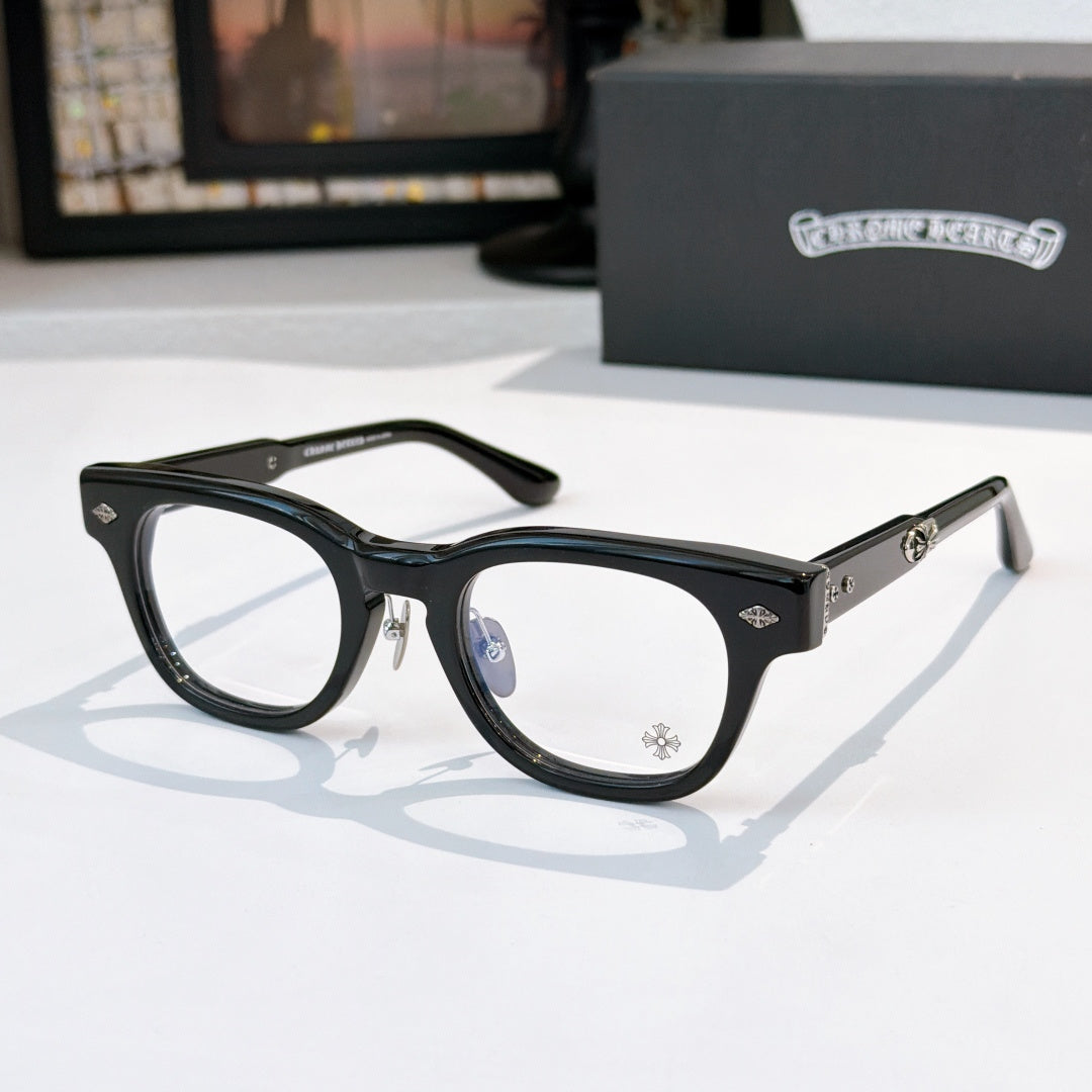 Glasses with black frames and clear lenses, patterned temple detail
