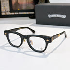 Glasses with black frames and clear lenses, gold-tone temple accents
