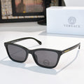 Versace sunglasses with black acetate frames and dark lenses, logo on temple.