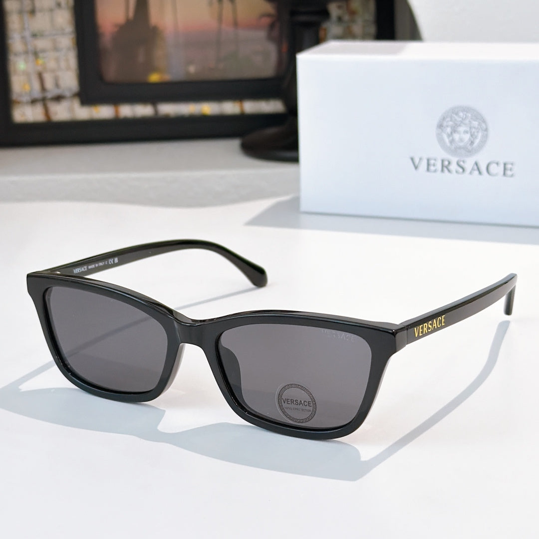 Versace sunglasses with black acetate frames and dark lenses, logo on temple.